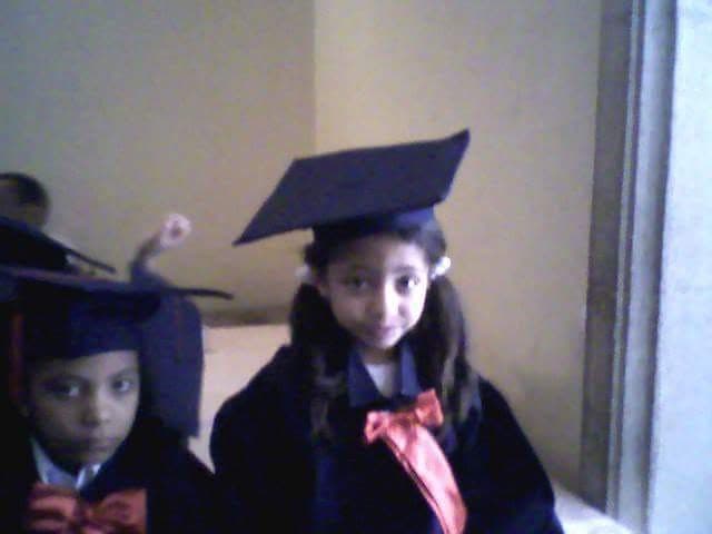 Magda as a young child in Egypt, hair tied back and covered